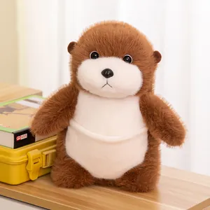 Soft brown and white otter plush stuffed animal toy sitting on a wooden desk as a gift