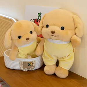 Two cute yellow plush puppy dogs in yellow lace onesies standing in a basket