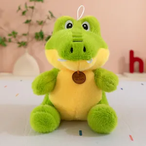 Close-up view of a cute green crocodile plush toy with soft fur and a small brown brand tag.