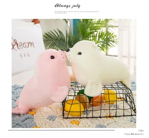 Detailed macro view of two cute realistic seal plush toys in a cozy home setting
