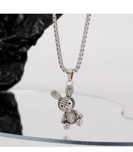 Close-up of silver bunny pendant with horizontal stripes on titanium steel chain.