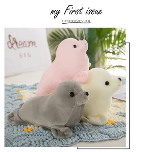 Three soft plush seal toys in pink, cream, and grey colors stacked together.
