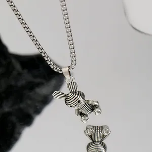 Close-up of hip hop titanium steel necklace with striped bunny pendant in silver