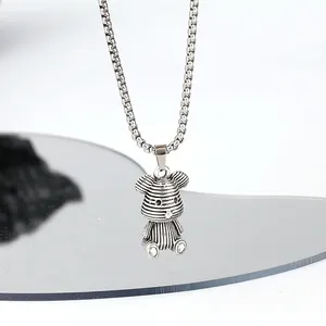Detailed close-up of a vintage silver striped bear pendant on a titanium steel chain