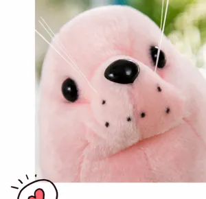 Close-up detail of a soft pink simulation seal plush toy with cute black eyes