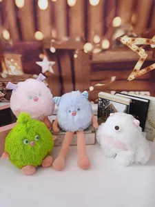Group of four colorful long-legged fluffy monster plush toys in a festive setting