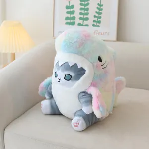 Detailed view of plush shark cat toy in colorful tie-dye costume on a cozy sofa