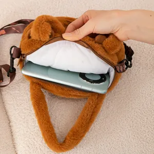 Detail view of the plush capybara bag interior showing smartphone capacity