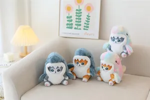 Group of four adorable shark cat plush toys in gray and rainbow colors on a cozy sofa.