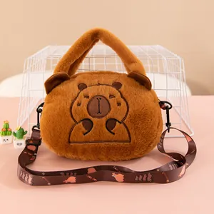 Adorable brown plush capybara handbag with embroidered face and adjustable shoulder strap.
