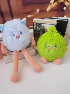 Detail view of fluffy long-haired monster plush toys in vibrant blue and green colors