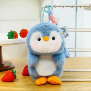 Detailed close-up of a cute blue penguin plush keychain showing soft fluffy fur texture
