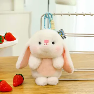 Adorable white bunny plush toy keychain with pink accents, perfect desk companion