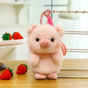 Close-up of cute pink plush pig toy with pink clip, soft texture and detailed face