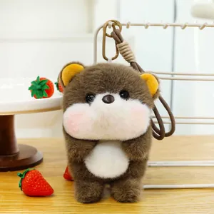 Detailed view of the cute brown bear plush toy pendant with strawberry props on a desk