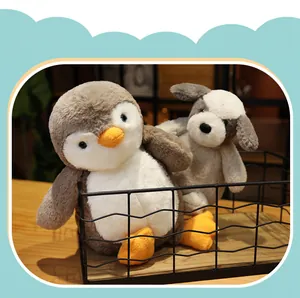 Close-up of cute penguin and puppy plush toys sitting in a black wire basket