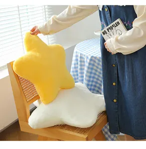 Soft yellow and white star-shaped plush cushions displayed in a cozy home setting.
