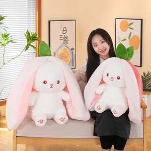 Strawberry and carrot bunny plush toys with long ears in a cozy indoor home setting