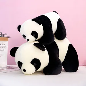 Two cute stacked panda plush toys in lying position on a soft pink background