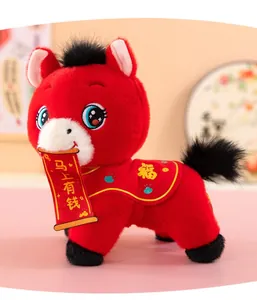 Detailed shot of a red 2026 Year of the Horse plush toy with a lucky scroll