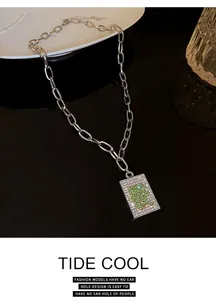 Close-up of Mahjong Zhong character pendant necklace with green and white rhinestones