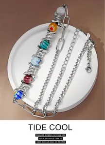 Close-up of silver thorn chain necklace with vibrant colorful glass beads detail