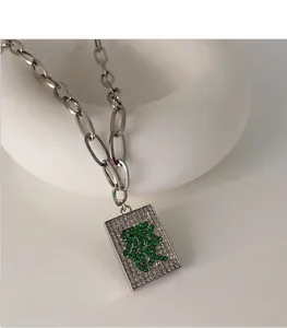 Close-up of Mahjong "Fa" character pendant necklace with sparkling green rhinestones