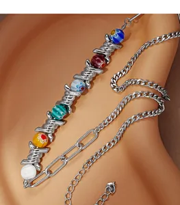 Detailed macro shot of colorful glass beads and barbed wire metal necklace design