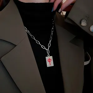 Macro view of Mahjong 'Zhong' character pendant necklace featuring sparkling crystals