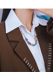 Detailed view of silver barbed wire necklace with colorful glass beads on model