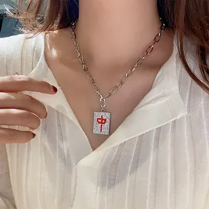Close-up of a silver-toned necklace featuring a sparkling Mahjong Red Zhong pendant