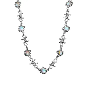 Punk style barbed wire choker necklace with iridescent moonstone pendants on white background
