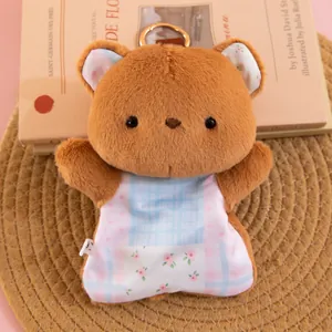 Detail showing the floral pattern and metal keyring hook of the cute plush bear.