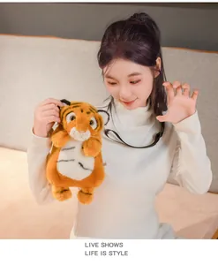 Close-up of a cute plush tiger crossbody bag held by a model in a lifestyle setting