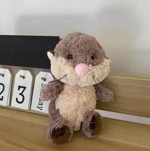 Close-up of a cute brown plush otter stuffed animal with soft fur texture on shelf