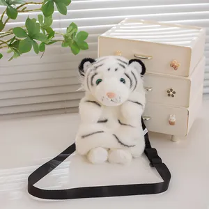 Realistic white tiger plush crossbody bag with black adjustable strap on a white table