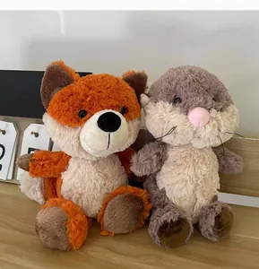 Close-up of cute forest fox and otter plush toys on a wooden shelf