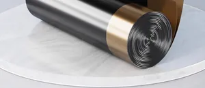 Close-up of thickened drawstring garbage bag roll with metallic gold and black finish