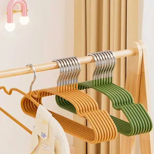 Kids non-slip hangers with matte resin texture and metal hooks in orange and green