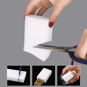 Versatile white nano sponge magic eraser being cut to custom size for kitchen cleaning.