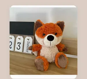 Cute and soft orange fox plush toy sitting on a wooden desk next to a flip calendar prop.