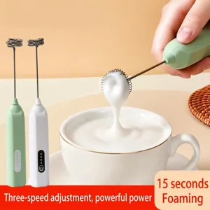 Portable electric milk frother for coffee, handheld mini foam maker in green and white.