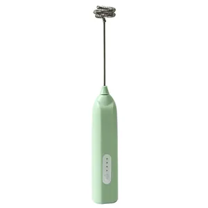 Portable handheld electric milk frother in mint green for smooth coffee foam whisking
