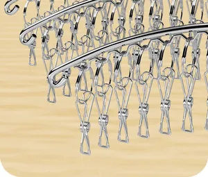 Detailed view of a stainless steel sock drying rack featuring multiple anti-rust clips