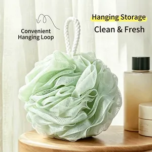 Soft light green bath loofah sponge with white hanging rope for refreshing shower.