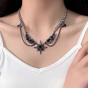 High-quality close-up of dark gothic wing and star necklace worn on a model's neck