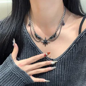 Gothic Y2K necklace with black wings and star pendant worn by a model in a close-up