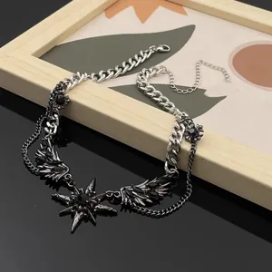 Detailed view of dark style wings and star pendant necklace with punk Y2K aesthetic design.