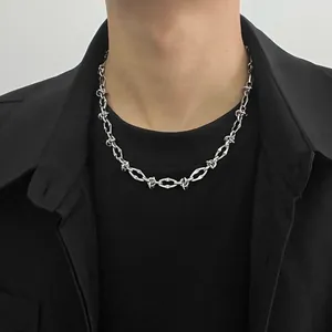 Detailed view of a silver titanium steel hip-hop chain necklace worn by a male model.