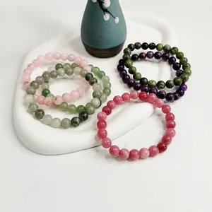Detailansicht verschiedener 8mm Naturkristall- und Achatperlenarmbänder auf einem Tablett
